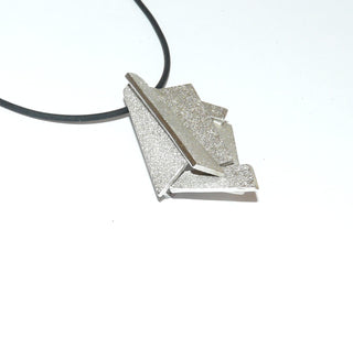 Handarbeit wandelbarer Unikat-Anhänger aus massiv 925 Silber, in variablen Positionen tragbar, ca. 32 mm x 20 mm, 4 verdeckte Schlaufen, besondere Oberflächenstruktur und polierten Kanten, in mehreren Ebenen geometrische Flächen verbunden, dreidimensional. Dazu paßt - Unikatschmuck nur erhältlich im Onlineshop von Juwelier & Goldschmiede Danilo! 