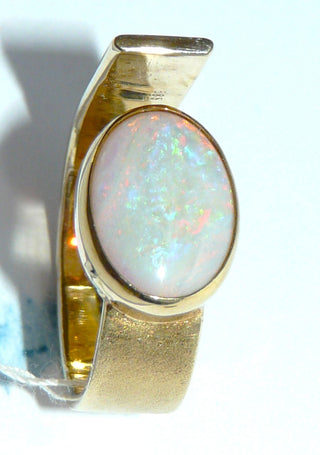 Handgearbeitetes Einzelstück, Unikat-Ring aus 585 Gelbgold poliert + mattiert, massiv verarbeitet mit einem großen, ovalen, weißen kristallinen australischen Opal, der wunderschön in blau, grün und rot schillert, sicher eingefaßt in einer Zargenfassung, Ringweite 57, Ringschiene oben offen, daher leicht in der Ringweite veränderbar -	Handarbeiten online bestellen bei Juwelier & Goldschmiede Danilo!