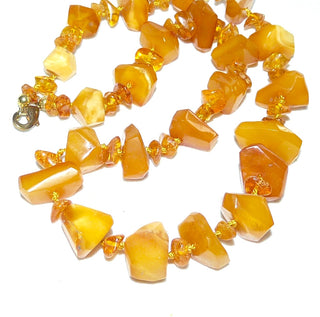 Handgefertigtes Einzelstück, kombinierte Vintage-Bernstein-Kette aus polierten, anfacettierte größeren und kleineren flachen Bernstein-Splitter, im Verlauf durchgeknotet, honigfarbener Butterscotch, Verschluß aus Gold-Doublé, Gesamtlänge 43 cm, um 1930 -	Vintage-Schmuck nur im Onlineshop von danilogold!