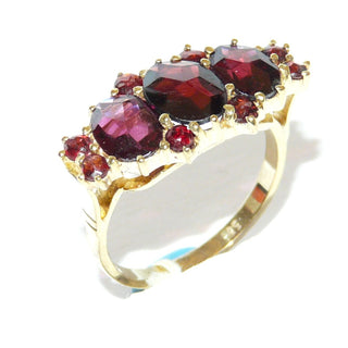 Vintage-Einzelstück, Granatring aus 333 Gold mit 8 kleinen, gleichgroßen, runden & 3 ovalen Almandin-Granaten im Sternschliff, Krappenfassungen in Reihe quer zum Finger nebeneinander, Ringweite 52, Reformschmuck im späten Jugendstil 1900-1915 - Goldschmiede Danilo