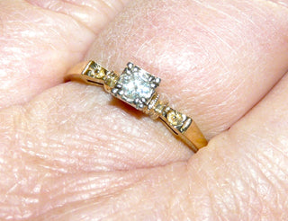 filigranes Einzelstück, antiker Brillantring, zierlicher Antragsring, Solitär-Verlobungsring aus 585 Gelbgold mit zwei kleinen Blüten im Ringoberteil und einem funkelnden Brillant von ca. 0,13 Karat W, sicher in einem Quadrat aus Weißgold im Pavé eingefaßt, Ringweite 57, poliert, später Historismus im Übergang zum Jugendstil um 1900 - Vintage-Schmuck nur im Onlineshop von danilogold!